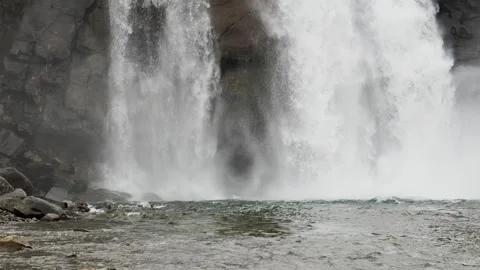 Powerful Waterfall Cascading Down Rugged Icelandic Cliffs in Slow Motion Stock Footage 339753573