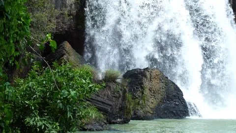 Powerful Waterfall Cascading Over Basalt Rocks and Green Foliage 스톡 동영상 343332215