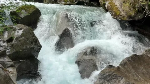 Powerful Waterfall Cascading Over Rocks in slow motion in the Austrian Alps.. Stock Footage 336191774