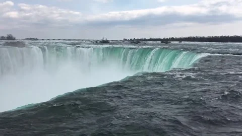 Powerful waterfall cascading over rocky edge with mist rising in Canada Stock Footage 310280085