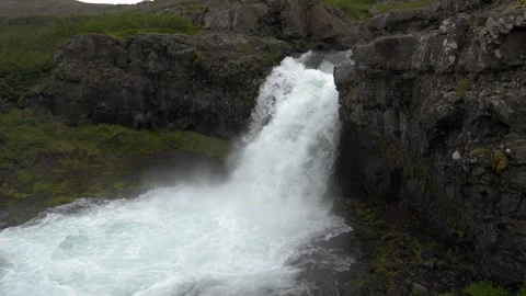 Powerful Waterfall Cascading Over Rugged Volcanic Cliffs in Iceland Stock Footage 339763853
