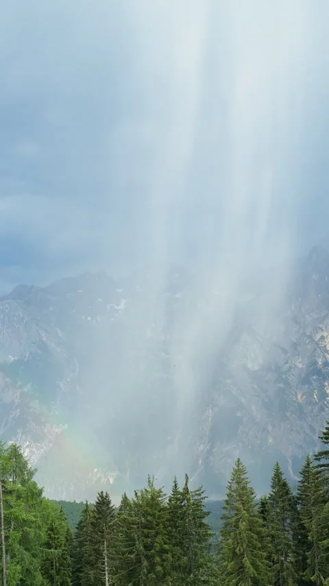 Powerful waterfall creating a rainbow in a mountain forest Stock Footage 341772070