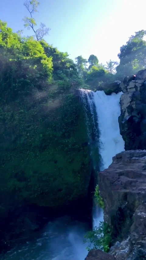 Powerful waterfall falling from cliff with mist tropical nature landscape Bali Stock Footage 332692539