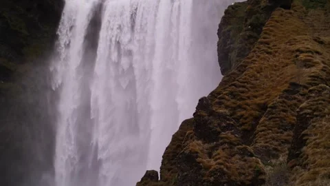 Powerful waterfall flowing between mossy cliffs in Iceland Stock Footage 306524890