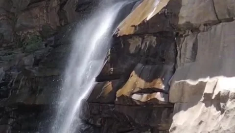 Powerful Waterfall Flowing Down Rocky Cliff In Bright Sunlight Stock Footage 344249326