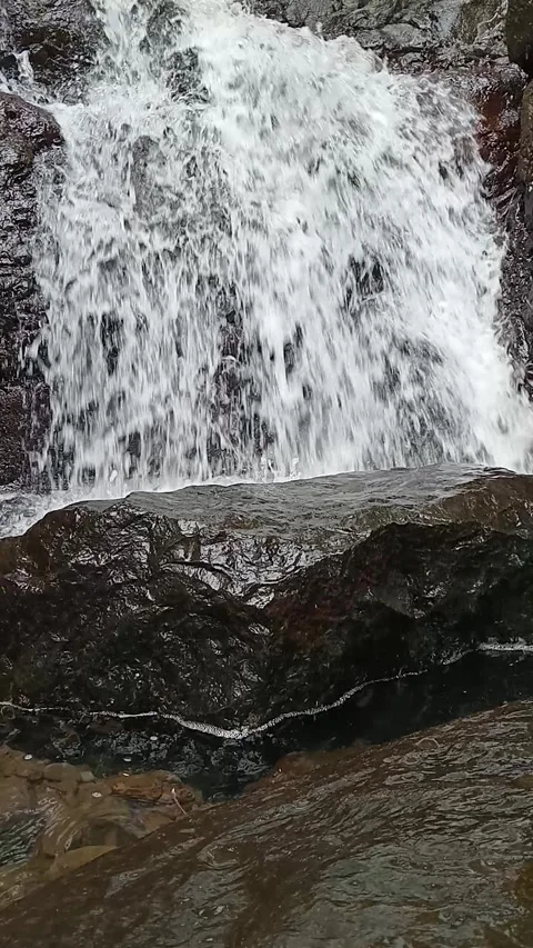 Powerful Waterfall Flowing Over Large Rock Close-Up Nature Shot Stock Footage 330541866