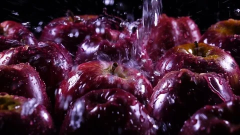 Powerful waterfall for group of fresh red apples, laying on black background Stock-Footage 78352557