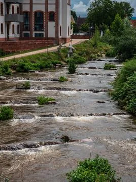 Powerful waterfall on the Kinzig river. Full-flowing river after the rains. Stock-Fotos