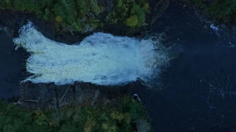 Powerful waterfall plunges down steep cliffs, seen from above Stock Footage 320500786