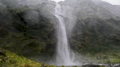 Powerful waterfalls cascading down the cliffs on the Milford Track in Fiord.. Stock Footage 295246697
