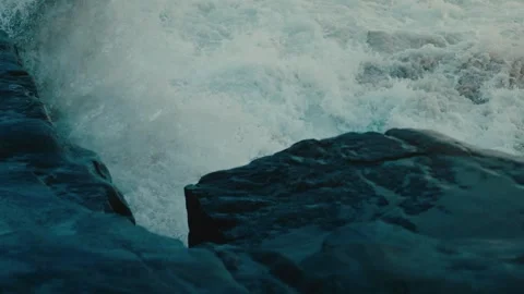 Powerful Wave Exploding Against Dark Rocks in a Burst of Sea Spray Slow Motion Video stock 342601729