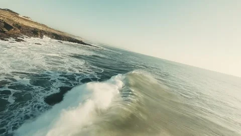 Powerful waves break on rocky shoreline Stock Footage 339792330