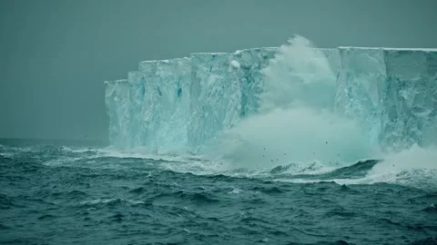 Powerful Waves Crashing Against Massive Ice Wall in Polar Waters Stock Footage 315094616