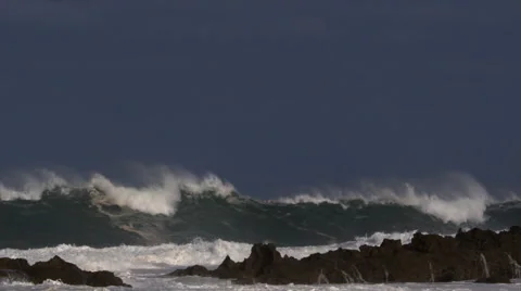 Powerful waves rolling to smash against a rocky reef Stock Footage 59525486