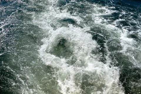 Powerful waves shot from a fast moving boat Stock Photos