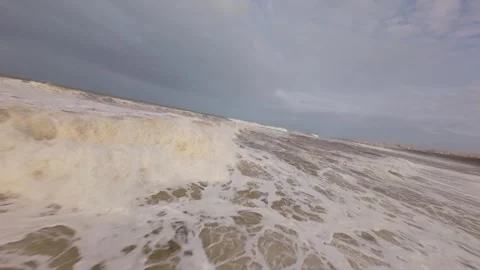 Powerful waves surge forward with force under overcast sky Stock Footage 344679633