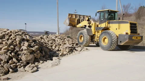 Powerful wheel loader or bulldozer working on a quarry or construction site Stock Footage 237525328