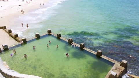 Powerful white swirling waves crashing into Ross Jones Rockpool Stock Footage 291369952