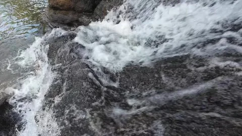 Powerful White Water Stream Flowing Across Dark River Rocks 4K Stock Footage 337309431