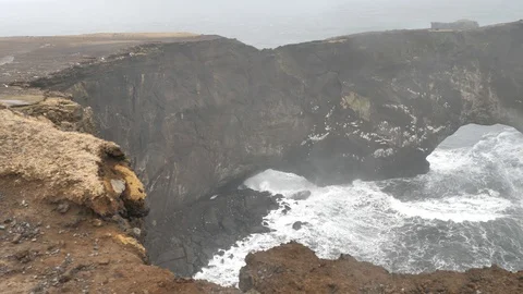 Powerful Wind And Waves Crash Against The Dyrholaey Arch, Iceland Stock Footage 97389886