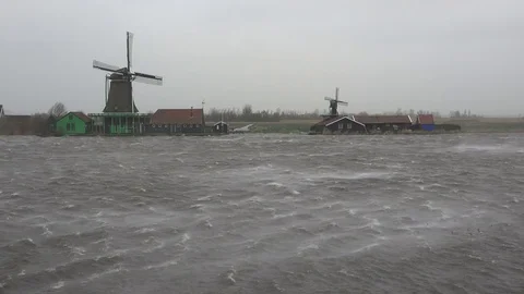 Powerful Winter storm battering Dutch landscape with windmills and river Stock Footage 85416823