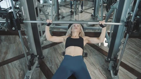 Powerful workout in slow motion showcases girl lifting weights at the gym Video stock 302117140