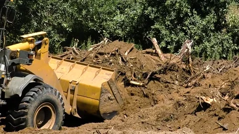 Powerful yellow bulldozer digs the ground Видео 222585542