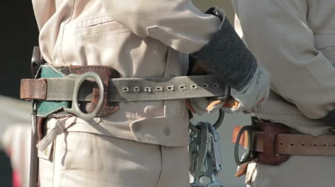 Powerline Workers strapping on work belt. Video stock 60607140