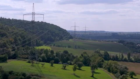 Powerlines in Harmony: Energy Infrastructure Amidst Pristine Forests 4K Stock Footage 282470146