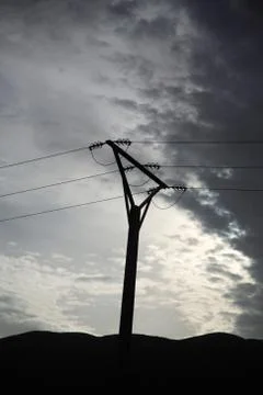 Powerlines silhouetted Stock Photos