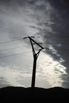 Powerlines silhouetted Stock Photos