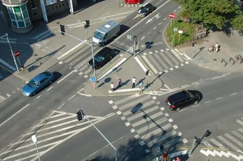 Poznan, Poland - July 11, 2014: Unidentified people and traffic on crossing o Stock Photos