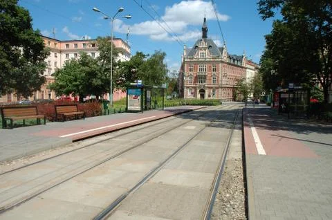 Poznan, Poland - July 13, 2014: Tram stops and unidentified people walking on Stock Photos