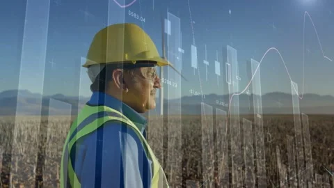 PPE tech standing wind farm data feed driving graphs passing around him and Stock Footage 332685741