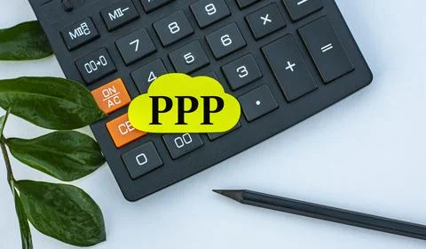PPP - word on a yellow note sheet on a white background with a calculator, pe Stock Photos