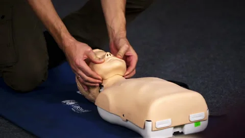 Practical course on a dummy's head. Medic showing medical exercise  Stock Footage 149434869