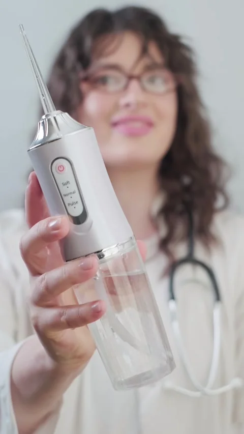 Practical guide from a dentist on how to use an irrigator for daily care of Stock Footage 307303542