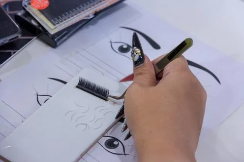 Practice eyelash   extension on tile .Artificial lashes,Work with tweezer, Photos