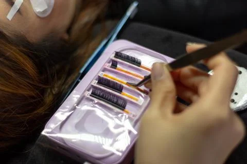 Practice eyelash extension on tile .Artificial lashes,Work with tweezer Stock Photos