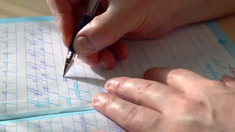 Practice in handwriting improvement in calligraphy notebook in slow motion Stock Footage 149963235