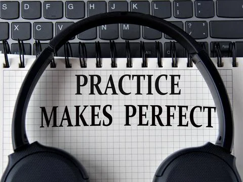 PRACTICE MAKES PERFECT -words on white notepad with keyboard and headphone .. Stock Photos