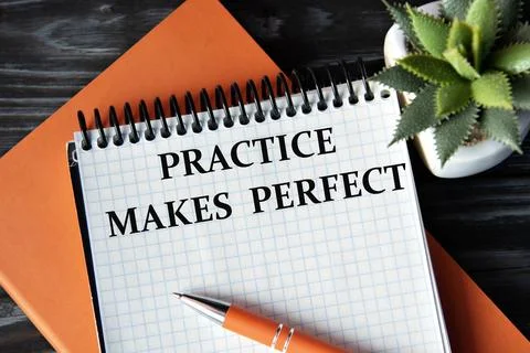 PRACTICE MAKES PERFECT - words in white notebook on dark wooden background .. Stock Photos