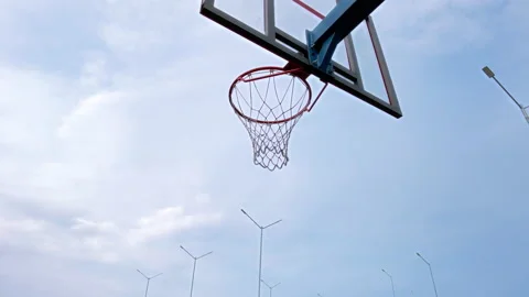 Practice on an outdoor athletic field to throw the ball into a basketball hoop Stock Footage 209667576