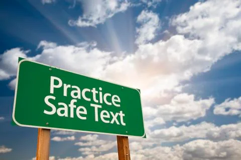 Practice Safe Text Green Road Sign with Dramatic Sky, Clouds and Sun. Stock Photos