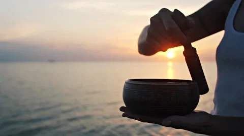 Practice with singing ritual bowl Stock Footage 64365076