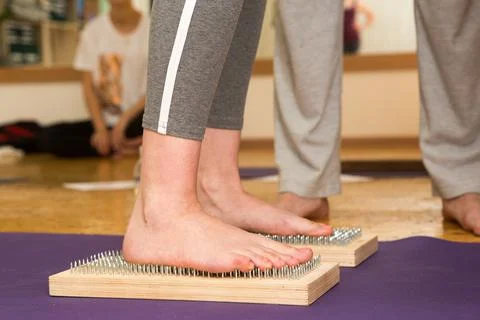 Practice of standing on nails. Close-up of a yoga man standing on a sadhu board Stock Photos