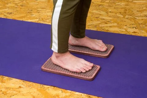 Practice of standing on nails. Close-up of a yoga man standing on a sadhu board Stock Photos