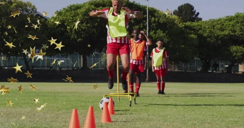 Practicing agility drills, soccer players with star animation overlay on field Stock Footage 303585527