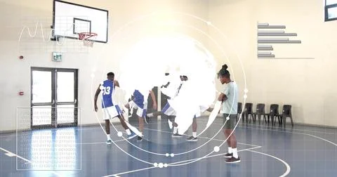 Practicing five players in blue jerseys, one gray T-shirt, passing at school gym 写真素材