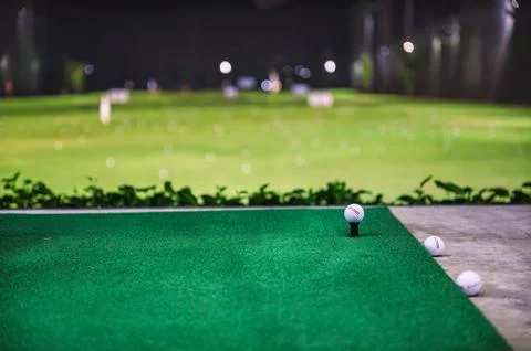 Practicing with golf swing on golf course at golf driving range Stock Photos